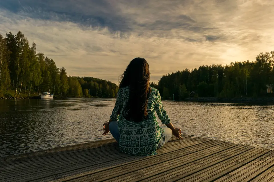 A woman meditating on the occasion of National Wellness Month